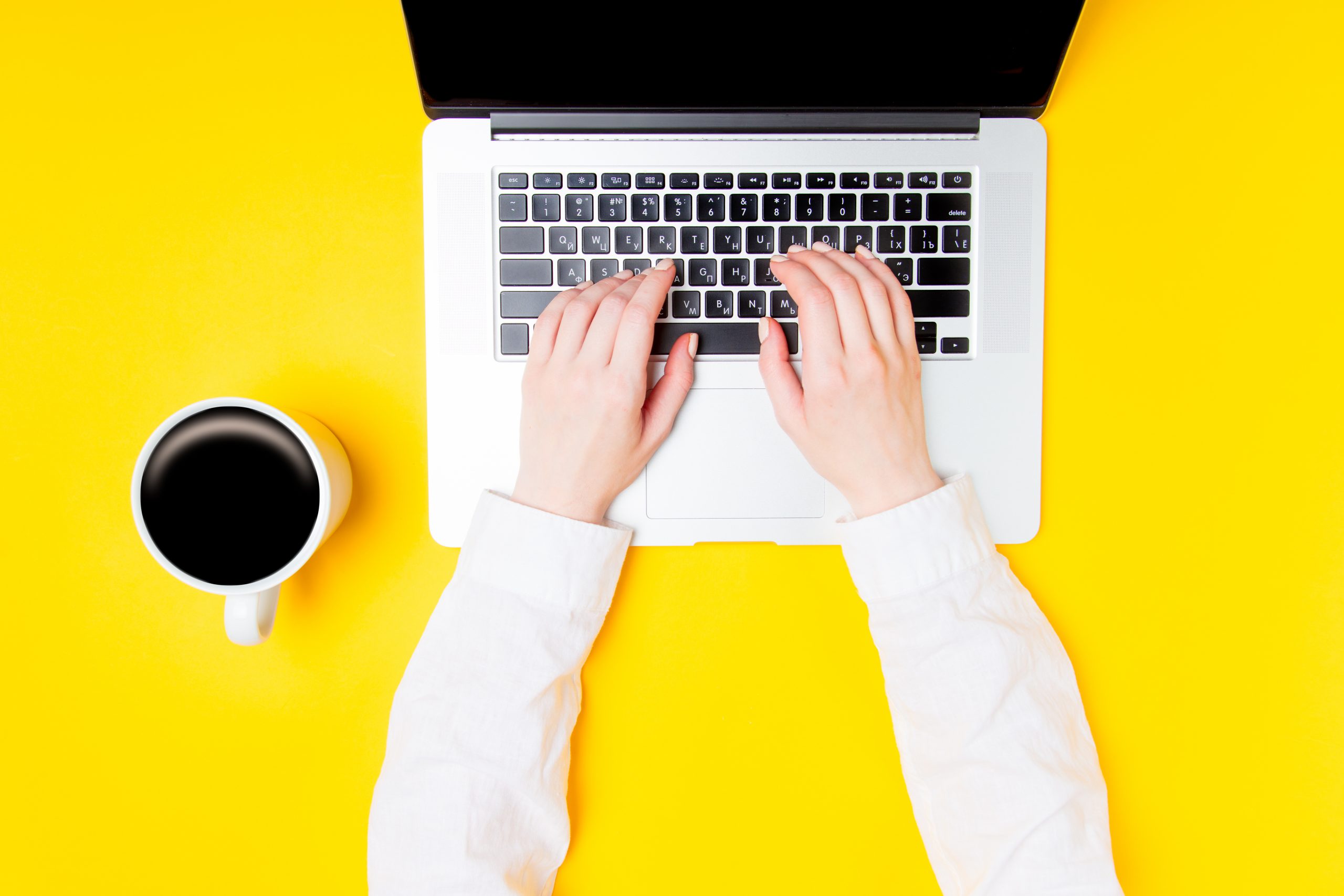 Businesswoman hands with laptop and cup of coffee